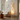 Modern living room with a tall floor lamp, beige sofa, and decorative items.