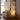 Modern floor lamp with stacked rectangular lampshades in a living room setting.