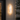 Rectangular outdoor wall light fixture on a building exterior with plants around.